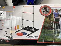Ladder and target toss game frames with plastic discs and cones, shown on box.