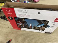 Original packaging box for RCA 32 inch TV/DVD combo, model RTDVD3215-E, showing picture of unit and some features like 3 HDMI ports.