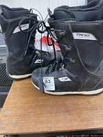 Left side view of Ride Orion snowboard boots showing outer material, laces, and front cinch ties.