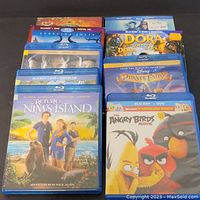 Photo of 9 Blu-ray/DVD movies including Return to Nim's Island, Dora, The Pirate Fairy, Angry Birds, and others.