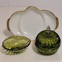 Photo showing green crystal candy dish with pineapple lid, small green glass dish, and white Fire King divided ovenware dish with gold trim