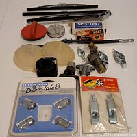 All car parts displayed including spark plugs, gas lids, Honda wheel locks, wipers, light bulbs