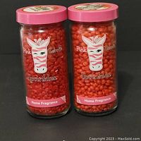 Two jars of Pink Zebra Sprinkles home fragrance with pink lids, showing bright red sprinkle beads inside. The label features a zebra logo and reads 'Sprinkles Home Fragrance'