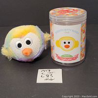 Photo showing plush Bitty Buddy chick and clear jar with scent wax and label.
