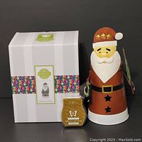 White box with Scentsy band showing Christmas Claus warmer, scent bar placed in front