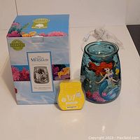 Photo showing the Scentsy warmer in box alongside a package of yellow Welcome Summer scented wax bars, both new.