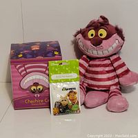 Cheshire Cat plush with original box and Muppets scent pack displayed together