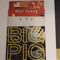 Four vintage vinyl albums stacked showing front covers from top: Big Pig, K.T.P., Ransom Note, Ted Wheel/Genya Raval