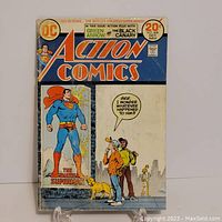 Front cover of Action Comics #428 October with Superman in the window and people looking on.