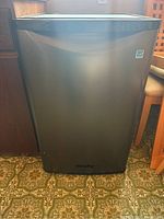 Front view of the black Danby mini refrigerator showing the full height and smooth finish.