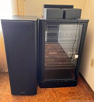 Floor-standing speaker next to cabinet showing overall size and cabinet with components