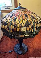 Full view of lamp showing stained glass shade and cast metal base