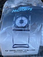 Photo of the box with the Air Innovations logo and model information showing the 12" Swirl Cool 2-in-1 fan with cord wrap.