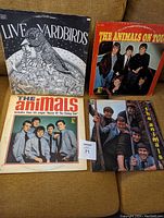Photo of four vintage vinyl albums: 'Live Yardbirds Featuring Page' and three From The Animals with photographic covers, showing signs of wear and age.