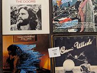 Top view showing all four album covers including The Doors, Alan Parsons Project Pyramid, Donovan Cosmic Wheels, and another colorful cover album.