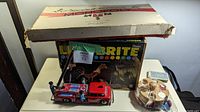 Hasbro Lite-Brite box and vintage tin firetruck with poker chips in plastic bag