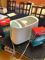 Side view of Honeywell HEV355C humidifier, white with two red Honeywell filter boxes on each side