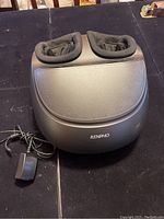 Front view of RENPHO black heated foot massager showing two fabric-lined foot compartments and power adapter.