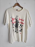 Front view of vintage white t-shirt featuring Michael Jordan graphic and Air Jordan Flight School text in red and black.