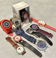 Overview of all ten watches showing their different bands, cases, and dials on gray background