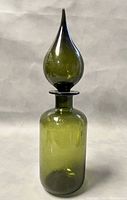 Front view of the 14-inch Mid-Century Modern Empoli blown glass genie bottle with teardrop stopper in olive green.