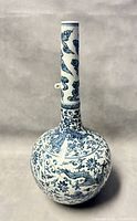 Front view of vase showing globe body and long neck with dragon motifs