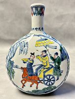 Front view showing figural horse-drawn carriage scene