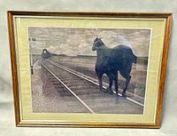 Front view of framed print showing entire artwork of horse near railroad track with approaching train.
