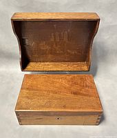 Wooden jewelry box closed with filing tray behind it, showing exterior and corner joinery.