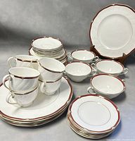 Overall display of the set showing stacked dinner plates, luncheon plates, dessert plates, teacups, saucers, and cream soup bowls.