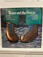Front cover of the album "Teaser and the Firecat" showing illustrated brown boots and song titles.