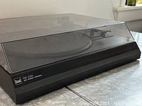 Closed view of the Dual CS 2100 HiFi Stereo Turntable with dust cover on, showing black case and branded logo.