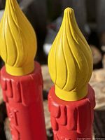 Close-up of yellow flame top of the vintage blow mold candle showing swirl design and details.