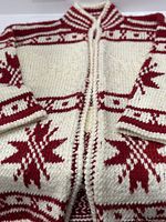 Close-up of the front body showing the red and white knit pattern with stripes and stars, no closure visible, Nehru collar detail