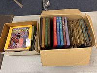 Two boxes showing a stack of vintage 78 RPM records and a collection of boxed LP sets with 'Great Men of Music' series and other musical LPs.