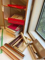 Shelf with stacked music books, red "Recorder Music" box, and recorders in boxes on window sill