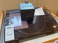 Sony turntable with dust cover and manual on top, photo taken to show condition and included manual.