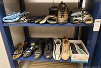 Shelf with 11 pairs of women's shoes including sandals, slippers, casual shoes, and sneakers