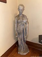 Full view of the 48-inch tall grey resin statue with draped robes, holding a bowl and small jug, standing barefoot on a base.