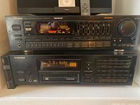 Front view of the Pioneer VSX-401 stereo receiver powered on, displaying tuner and various control buttons.