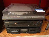 Front view of Technics turntable on top, Pioneer CD recorder in middle, Sony dual cassette deck on bottom, showing unit faces and controls.