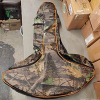 Top view of camouflage crossbow bag showing overall shape and orange piping.