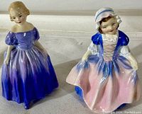 Two Royal Doulton bone china figurines together showing front view