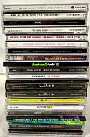 Photo of CD spines showing artists and album titles including Pink Floyd, Stevie Ray Vaughan, MGK, The Rolling Stones, French Montana, and others.