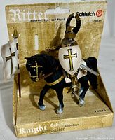 Front view of Schleich White Knight on Horse figure in original packaging showing knight on black horse with sword and shield