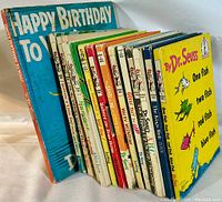 Photo showing a selection of vintage children's books including multiple Dr. Seuss titles with colorful, worn covers.