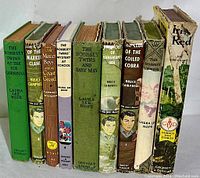 Photo showing spines of 9 hardcover vintage books from 1940s-50s with titles by Jim Kjelgaard, Laura Lee Hope, Bruce Campbell.
