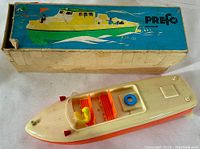 Photo of vintage plastic motorboat toy and original box showing top and front of box with colorful artwork labeled PREFO Dresden.