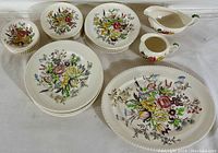 Full set including platter, gravy boat, creamer, side dishes, dessert, salad, and dinner plates arranged and photographed showing the colorful floral pattern and scalloped edges of Windsor Ware.