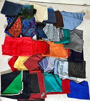 Top view of entire lot displaying 28 assorted silk pocket squares and kerchiefs in various colors and patterns, neatly arranged on a flat surface